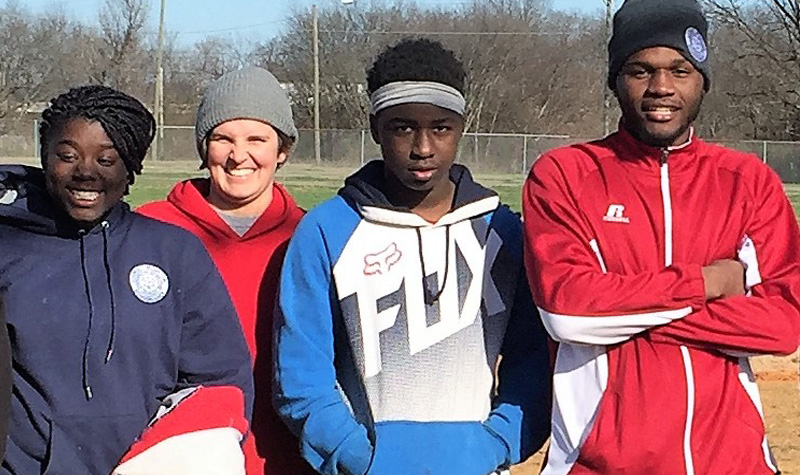 Ashley Cofield with students on baseball field