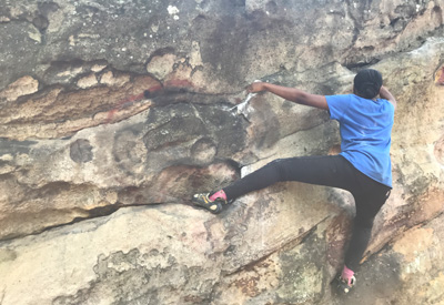 Intern bouldering on the boulders that they steward
