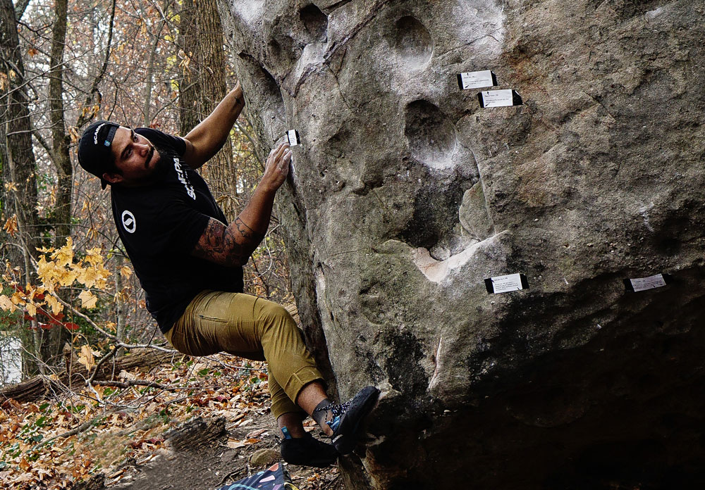 participant climbing boulder