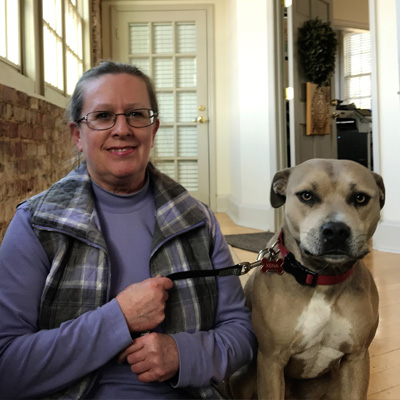 Bookkeeper, Carol, sitting with her dog, Xena