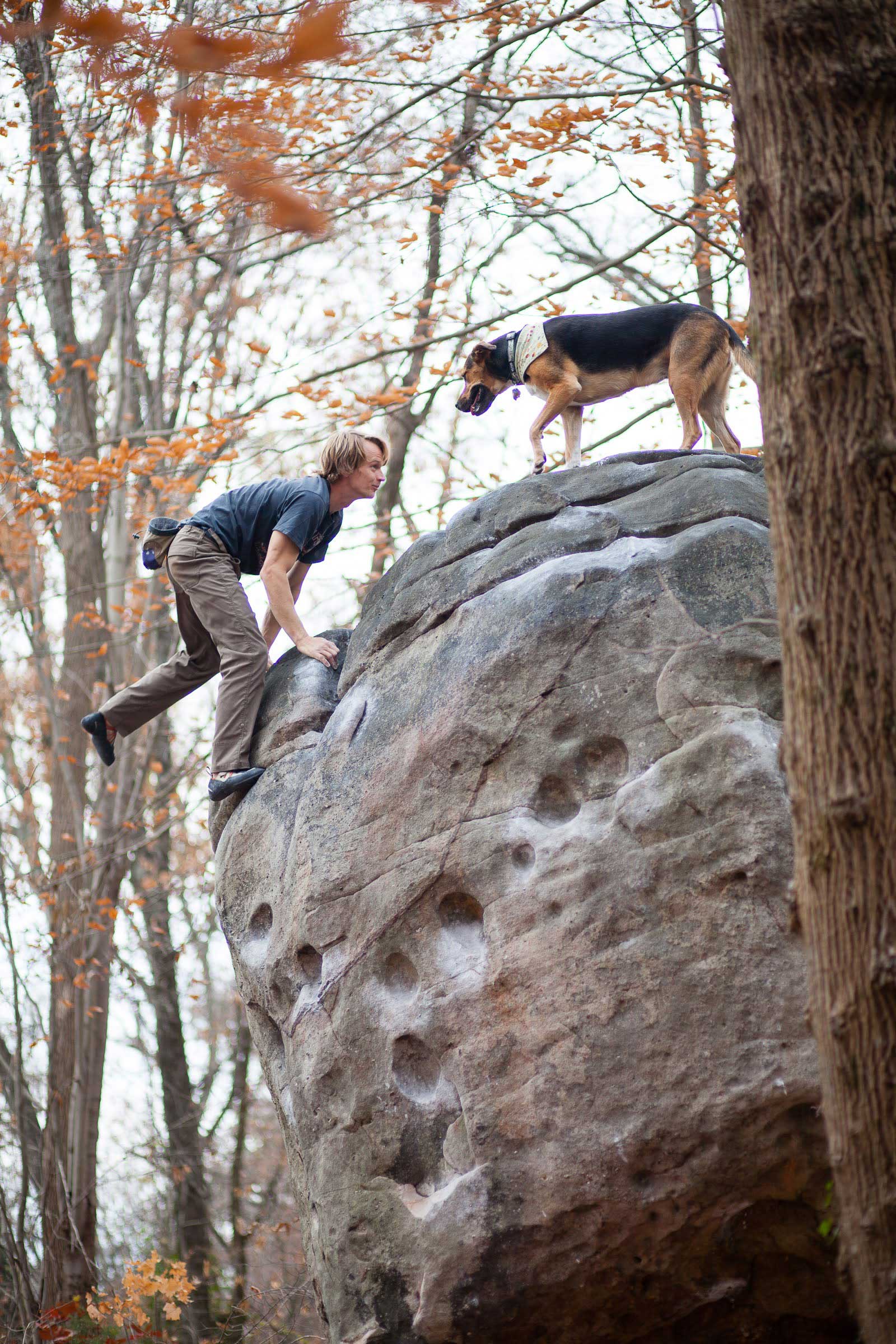 Guy climbing with his dog