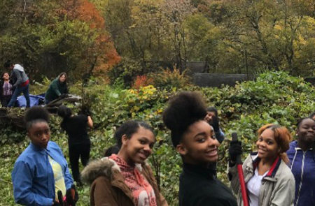 Howard Freshman working in the Pollinator Garden