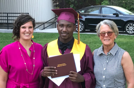 Ashley and Robyn standing with Micah after he graduated