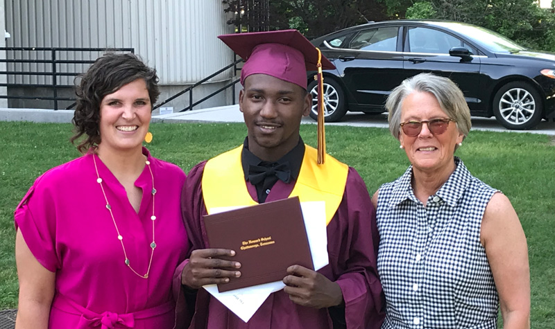Ashley and Robyn standing with Micah after he graduated