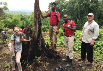 Interns with Volunteer who brought some native plants to put into the pollinator garden