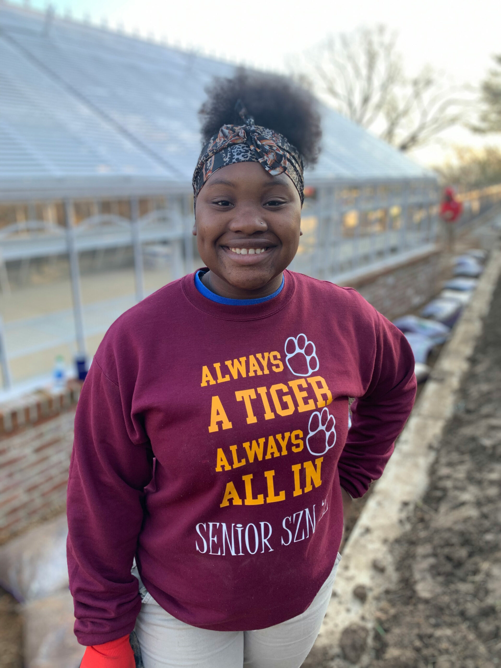 Intern Ramiyah outside greenhouse