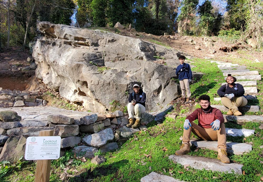 Interns working on boulder