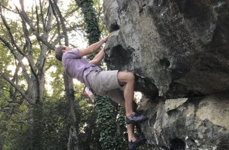 Climber on the boulder "Cliff Hanger"