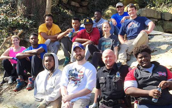 interns, city police, and Rotaracs all sanding together and smiling